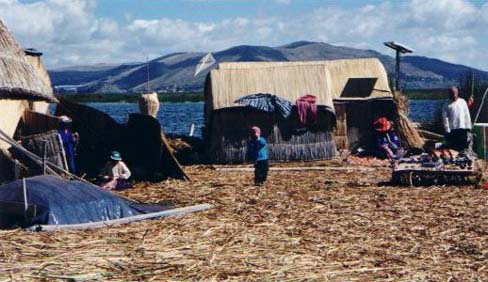 Boy flying a kite on the floating Uros Island of Santa Maria on Lake Titicaca