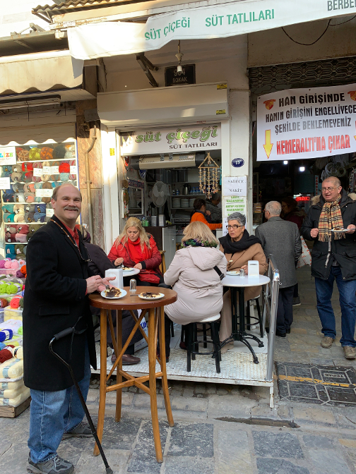 Enjoying a specialty dessert at Süt Çiçegi, Izmir market