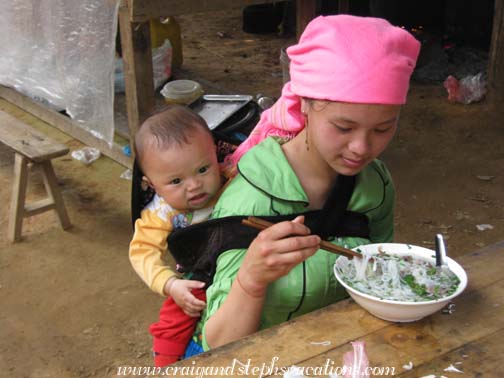 Eating noodles at Coc Ly market