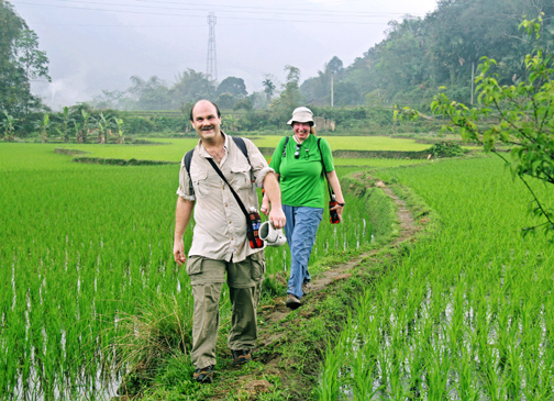 Craig and Steph hike through the rice paddies (Photo courtesy of Cuong)